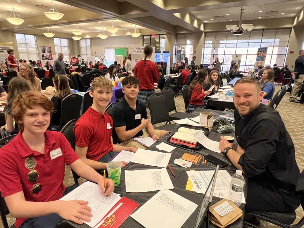 Students seated in a large room.